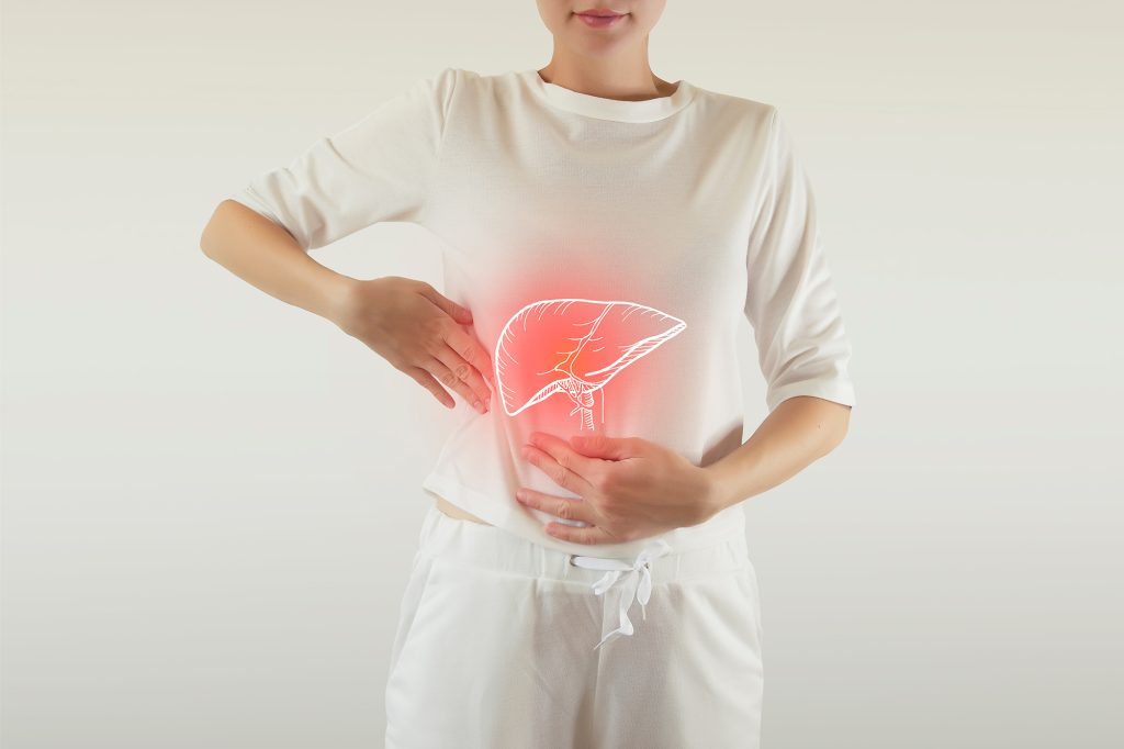 Woman holding the side of her stomach, with a diagram of her pancreas